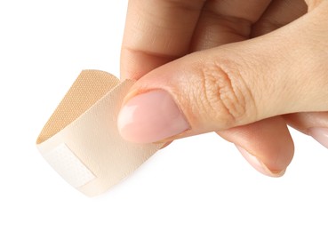 Photo of Woman putting medical adhesive bandage on white background, closeup