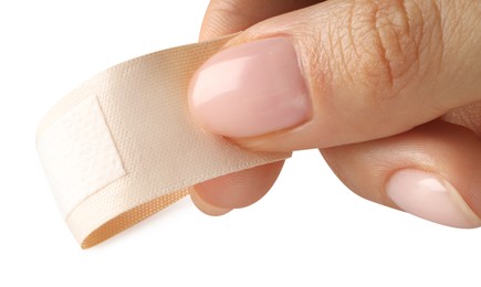 Photo of Woman putting medical adhesive bandage on white background, closeup