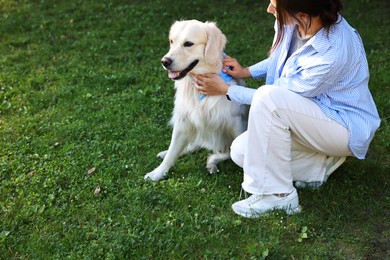 Owner with cute Golden Retriever dog outdoors, closeup. Space for text