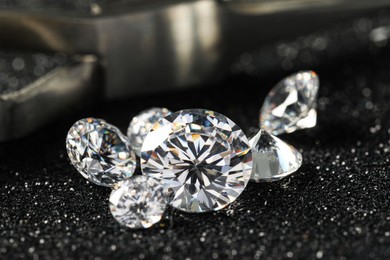 Beautiful dazzling diamonds on dark shiny background, closeup