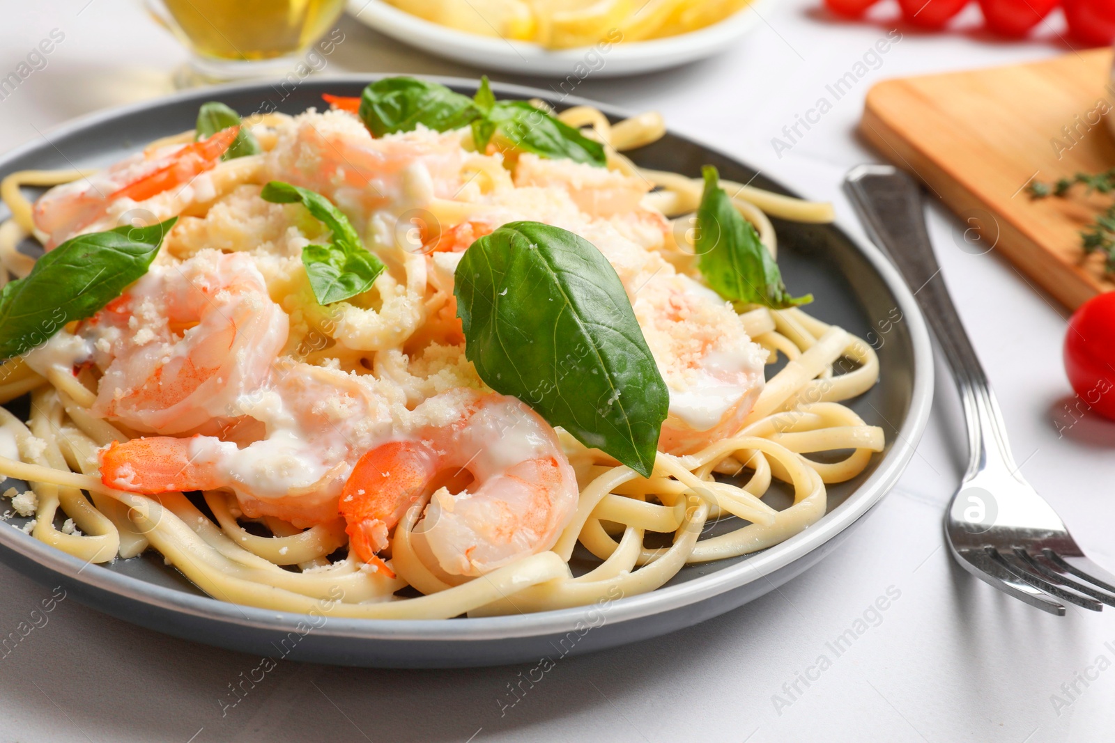 Photo of Tasty pasta with shrimps on white table, closeup