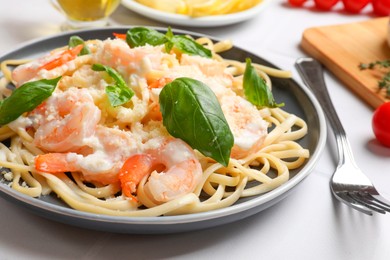 Photo of Tasty pasta with shrimps on white table, closeup