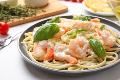 Photo of Tasty pasta with shrimps on white table, closeup