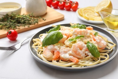 Photo of Tasty pasta with shrimps served on white table, closeup