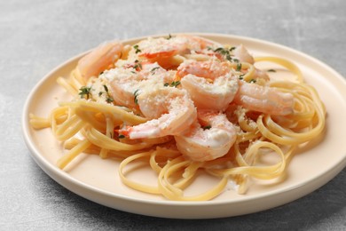 Photo of Delicious pasta with shrimps on grey table, closeup