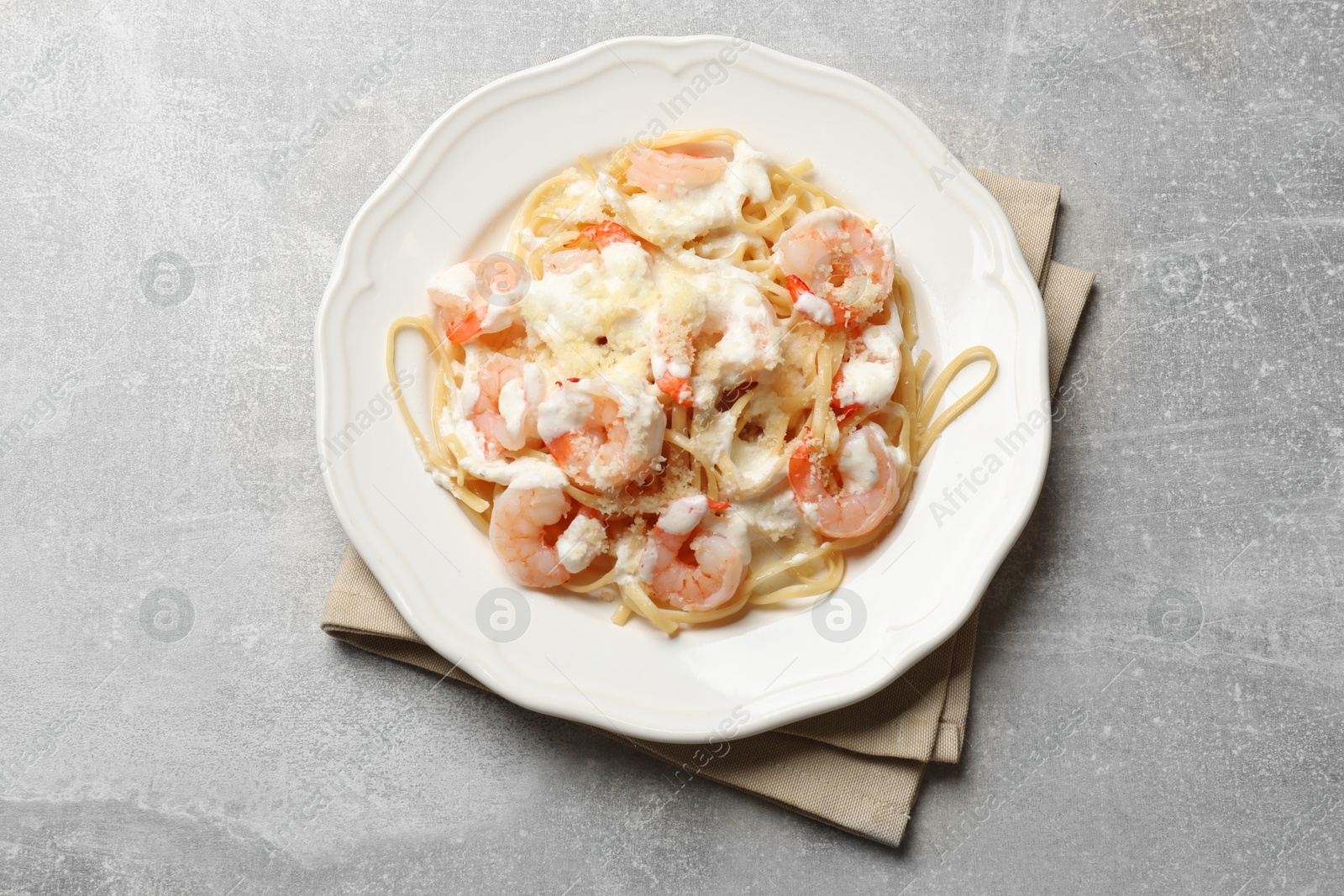 Photo of Delicious pasta with shrimps on light table, top view