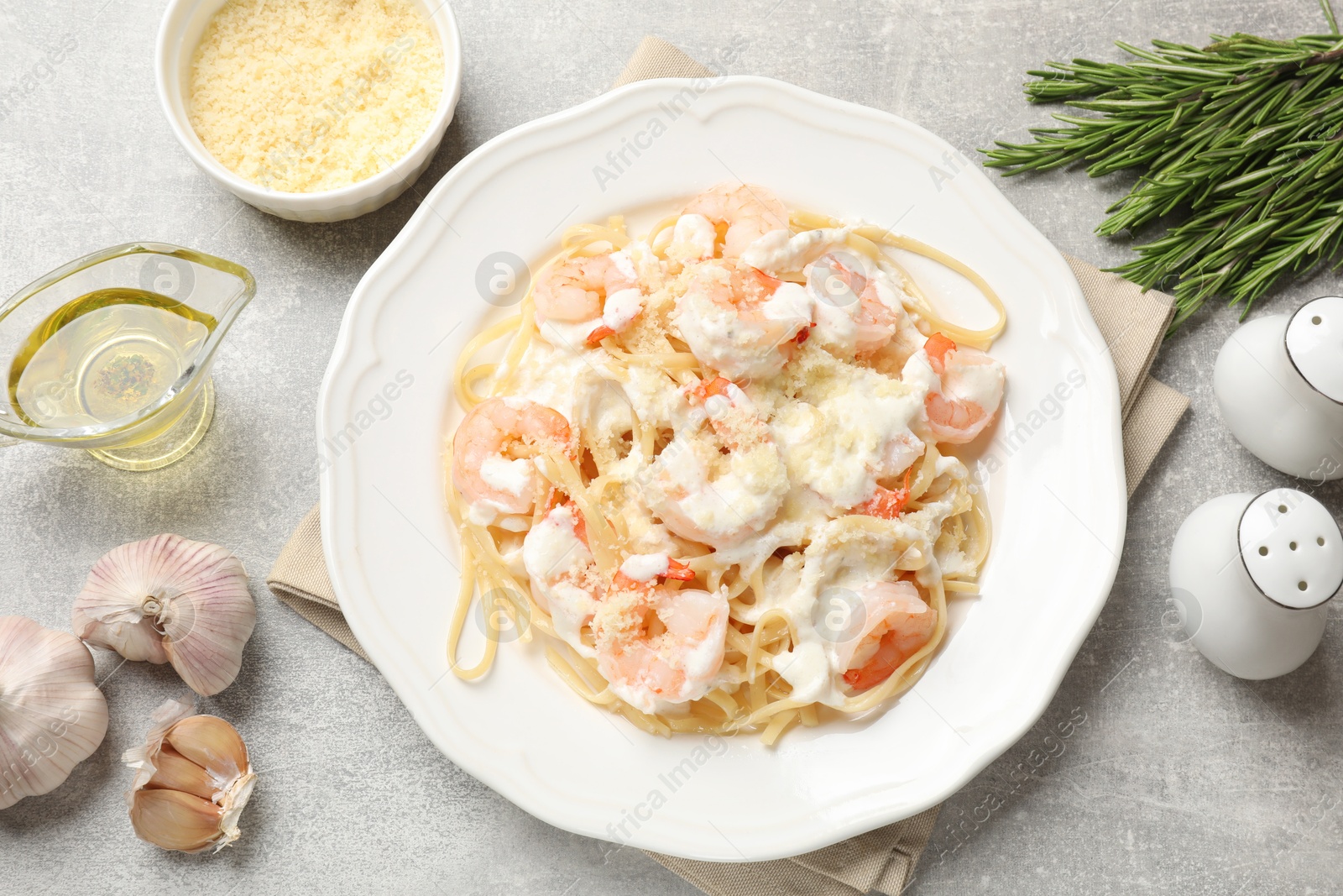 Photo of Delicious pasta with shrimps served on light table, flat lay