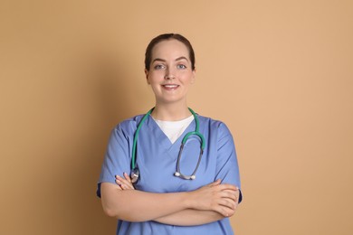 Photo of Portrait of professional nurse with stethoscope on dark beige background