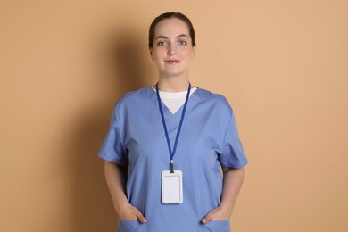 Professional nurse with badge on dark beige background