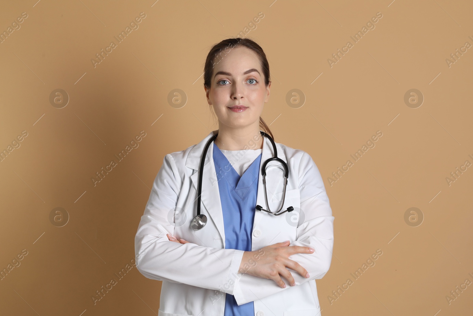 Photo of Portrait of professional nurse on dark beige background