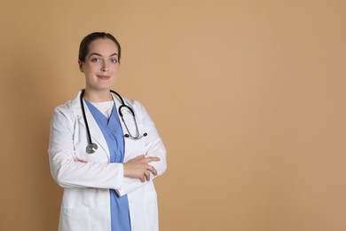 Portrait of professional nurse on dark beige background. Space for text