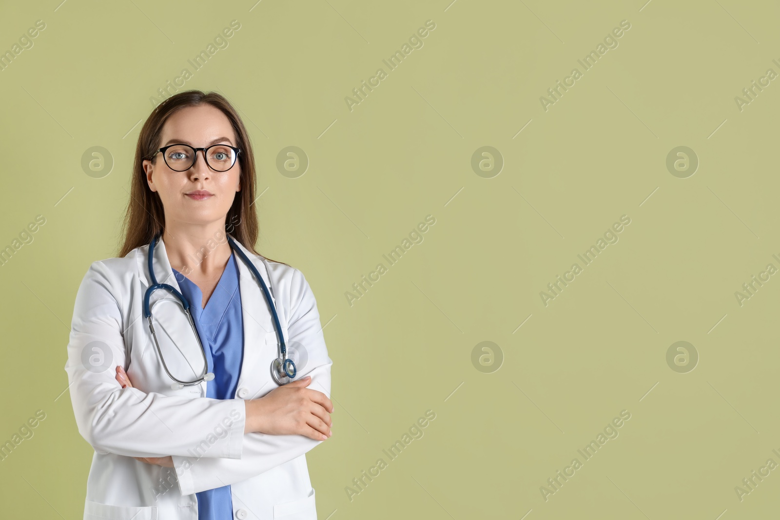 Photo of Portrait of professional nurse with stethoscope on pale green background. Space for text