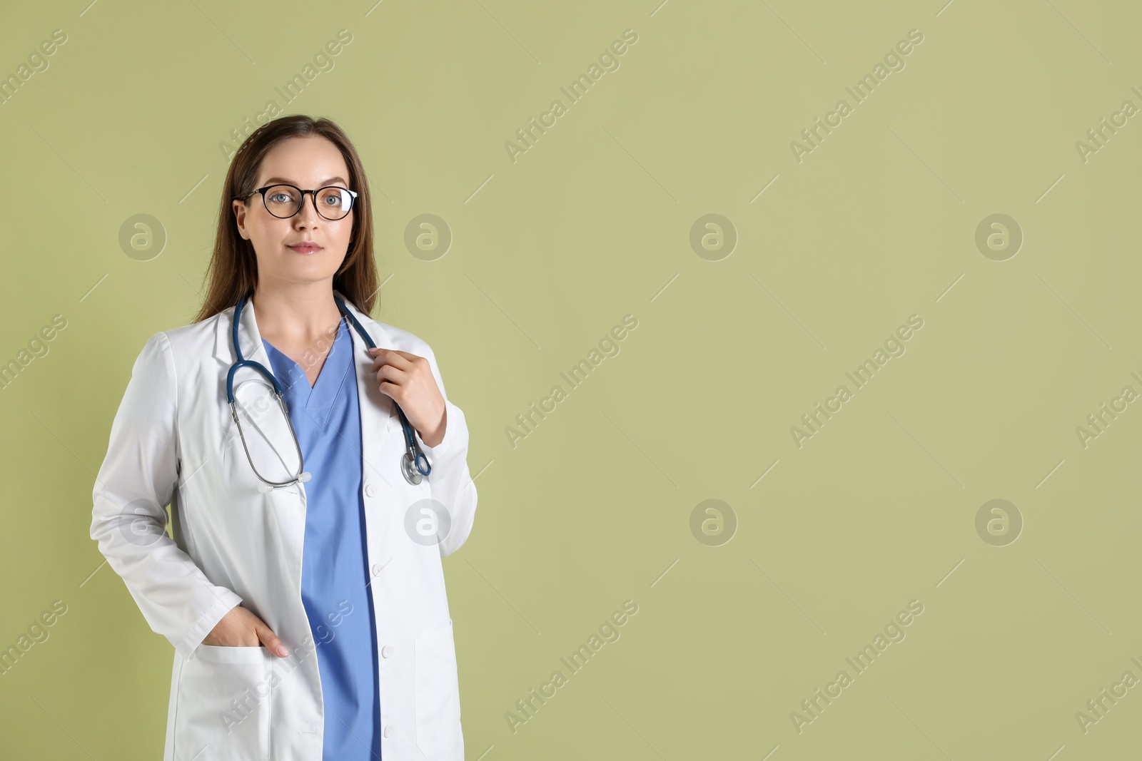 Photo of Portrait of professional nurse with stethoscope on pale green background. Space for text