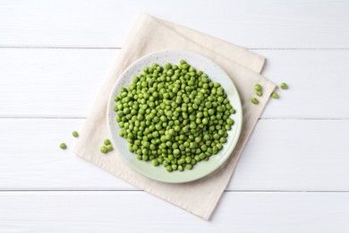 Fresh green peas on white wooden table, top view