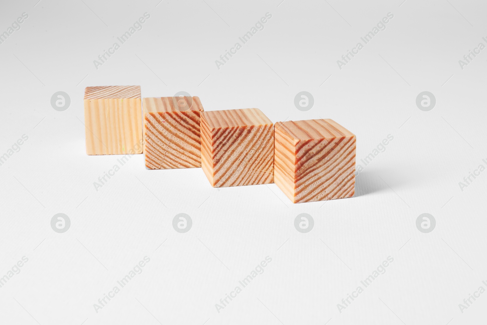 Photo of Many blank wooden cubes on white background