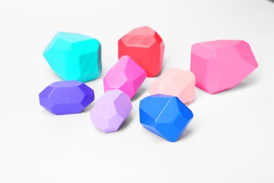 Photo of Many colorful balancing stones on white background