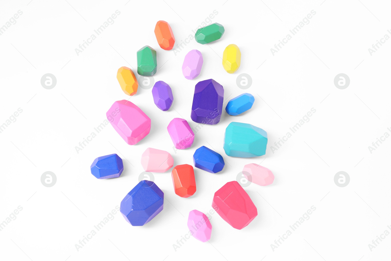 Photo of Many colorful balancing stones on white background, top view