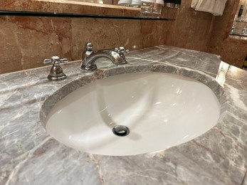 Photo of Stylish vessel sink with faucet in bathroom