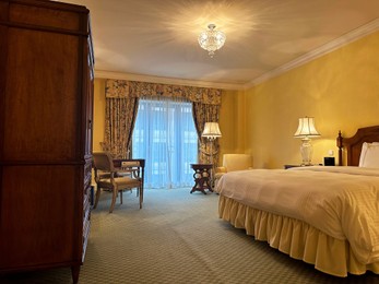 Luxury hotel interior. Comfortable large bed and modern furniture in stylish room