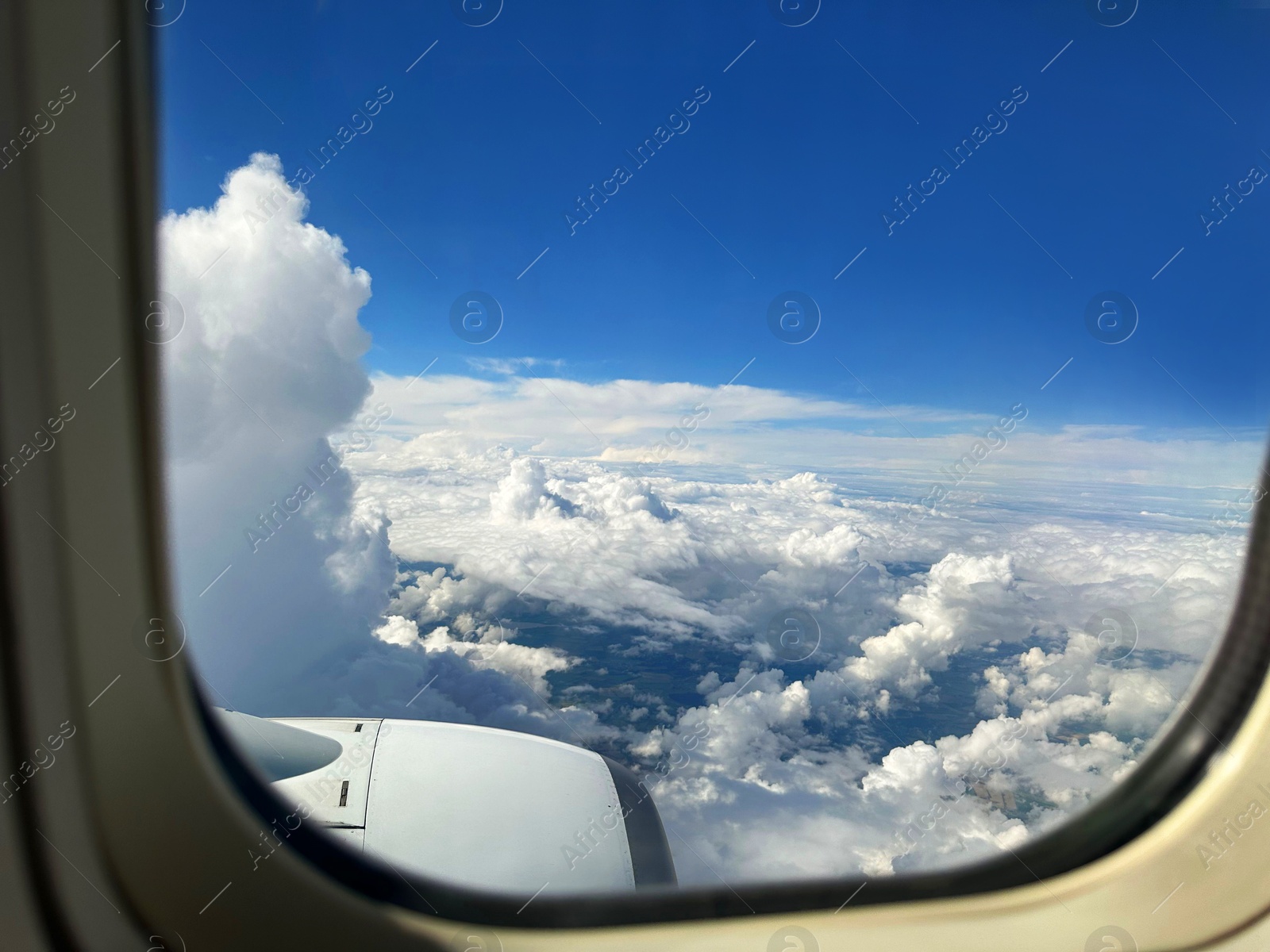 Photo of Beautiful blue sky with fluffy clouds, view from plane window