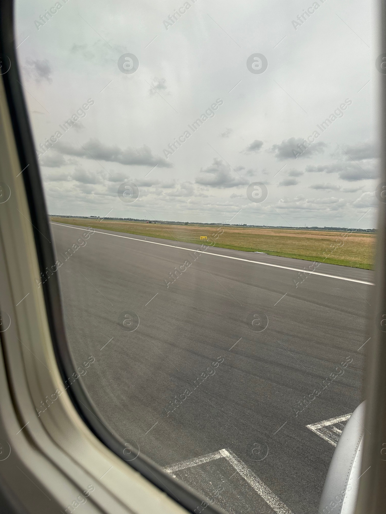 Photo of View on runway and surroundings through plane window