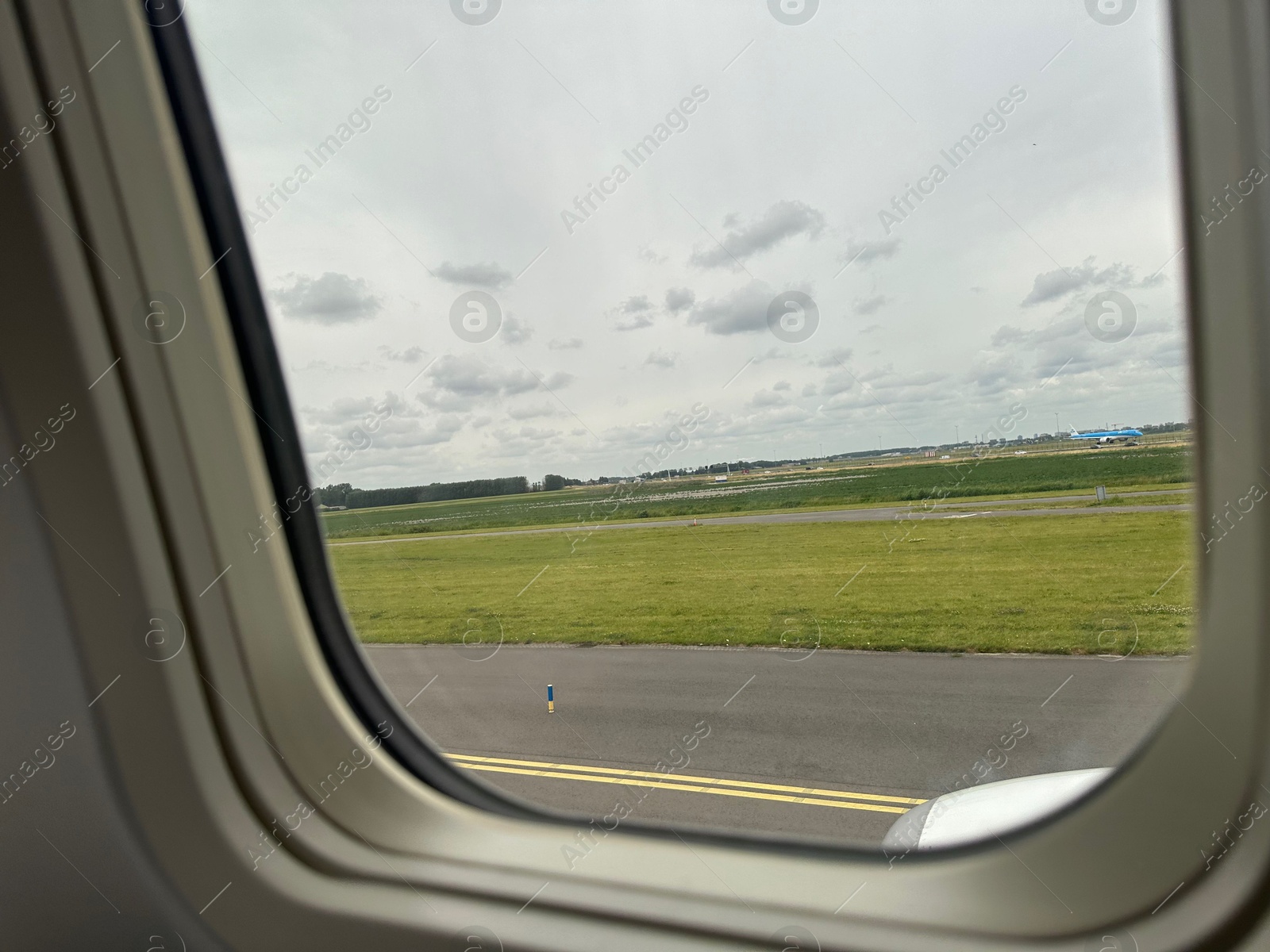 Photo of View on runway and surroundings through plane window