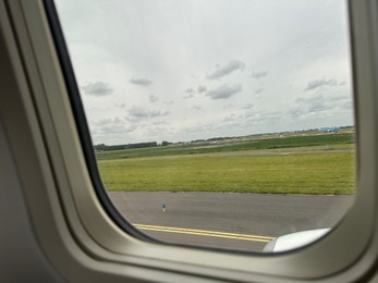 Photo of View on runway and surroundings through plane window