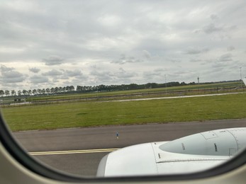 Photo of View on runway and surroundings through plane window