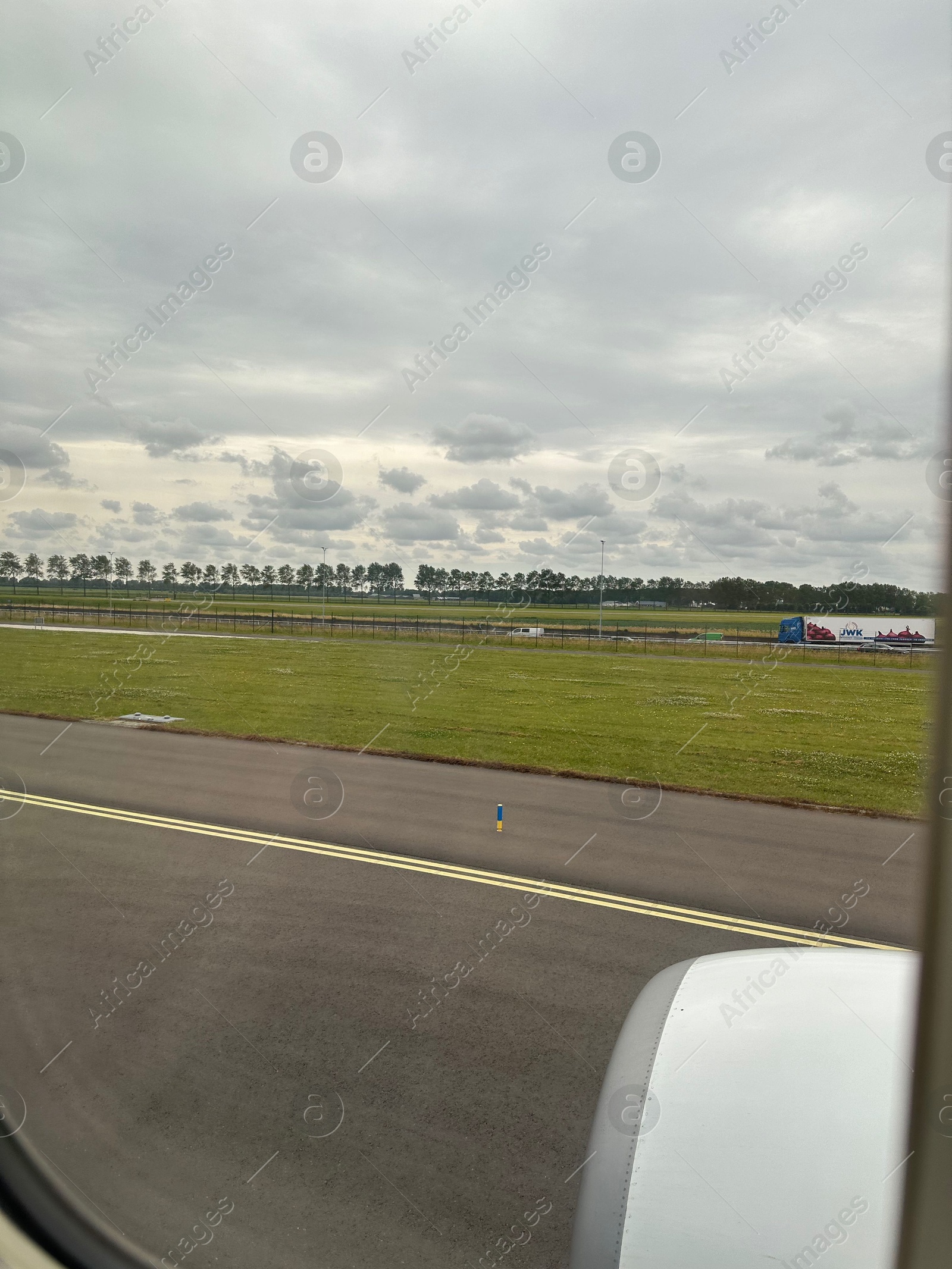 Photo of View on runway and surroundings through plane window