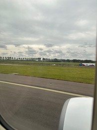 Photo of View on runway and surroundings through plane window