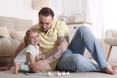 Happy family. Father and his cute little daughter at home