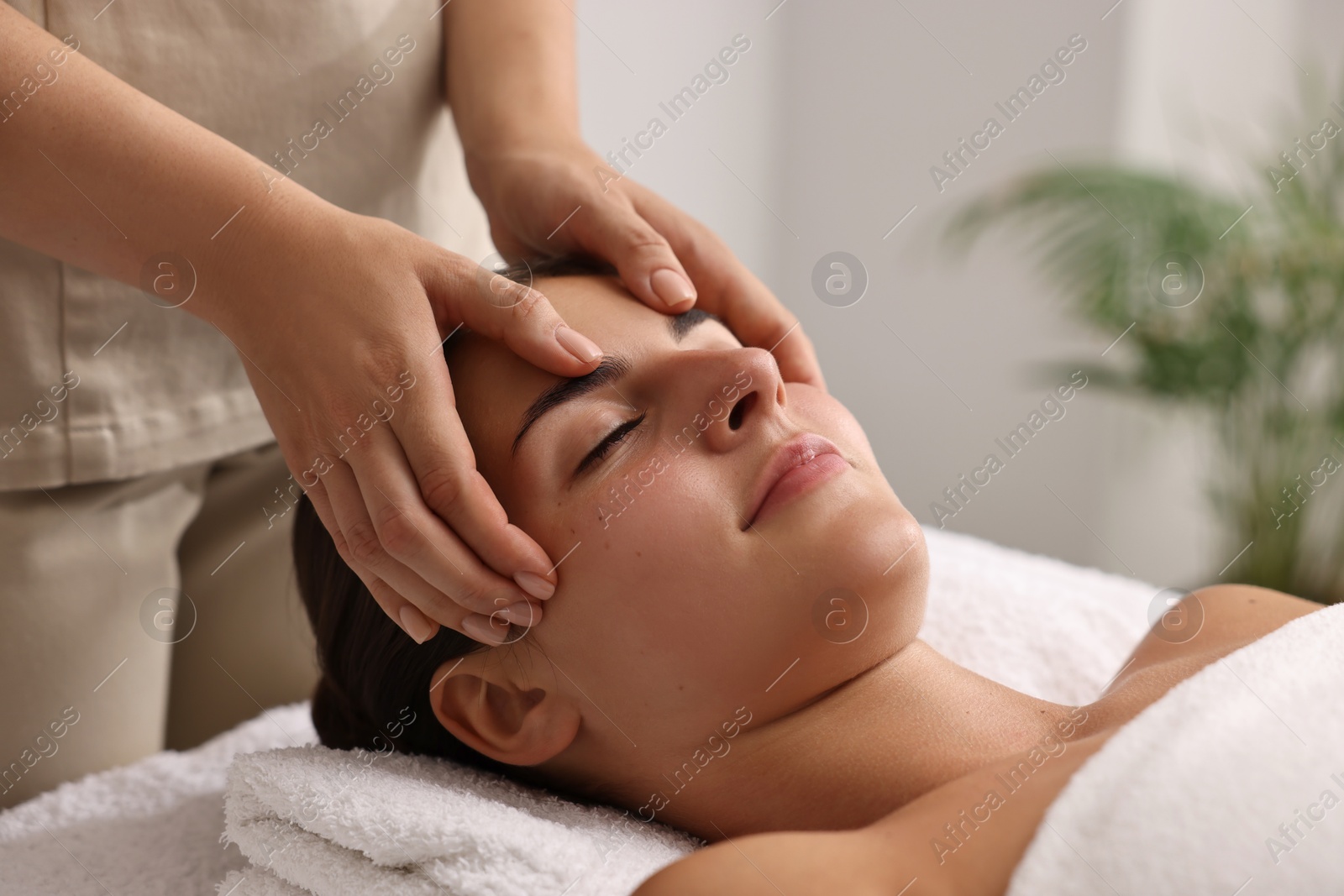 Photo of Attractive woman enjoying face massage, closeup. Beauty procedure