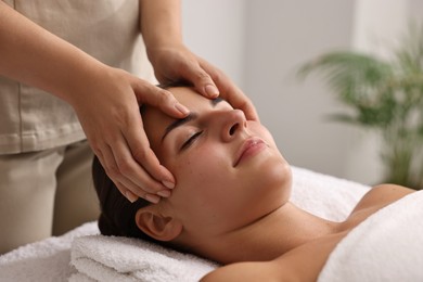 Attractive woman enjoying face massage, closeup. Beauty procedure