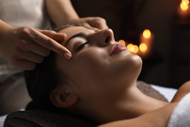 Photo of Attractive woman enjoying face massage, closeup. Beauty procedure