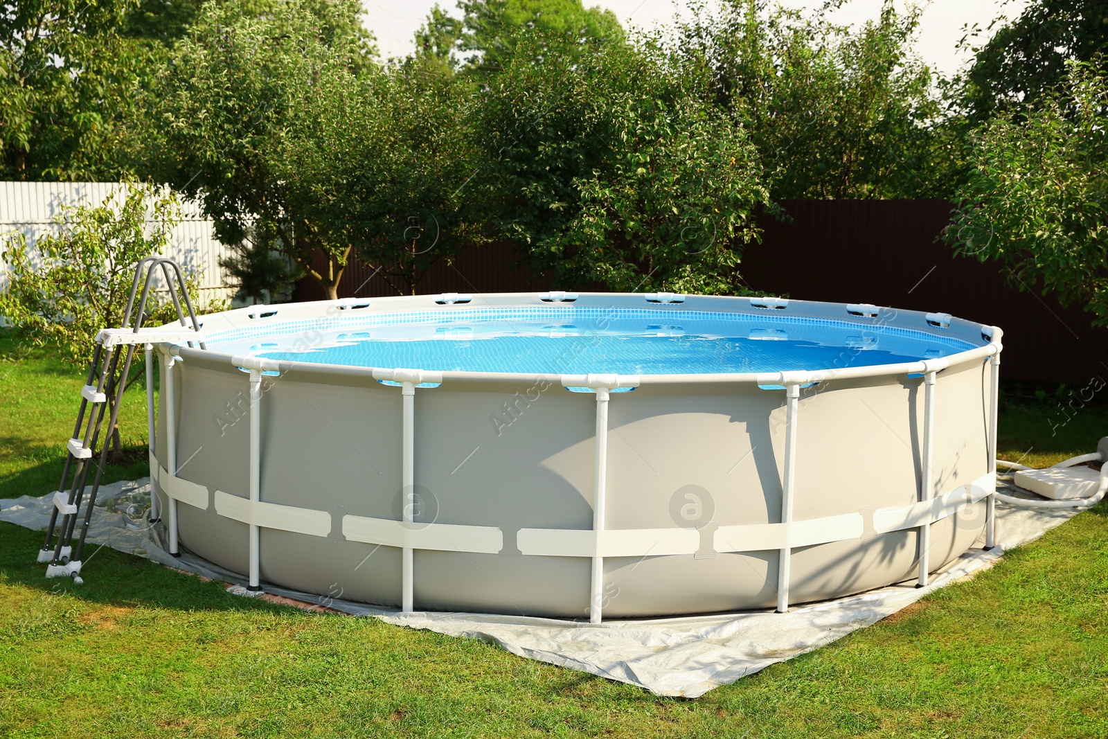 Photo of Above ground swimming pool outdoors on sunny day