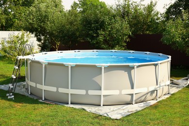 Above ground swimming pool outdoors on sunny day