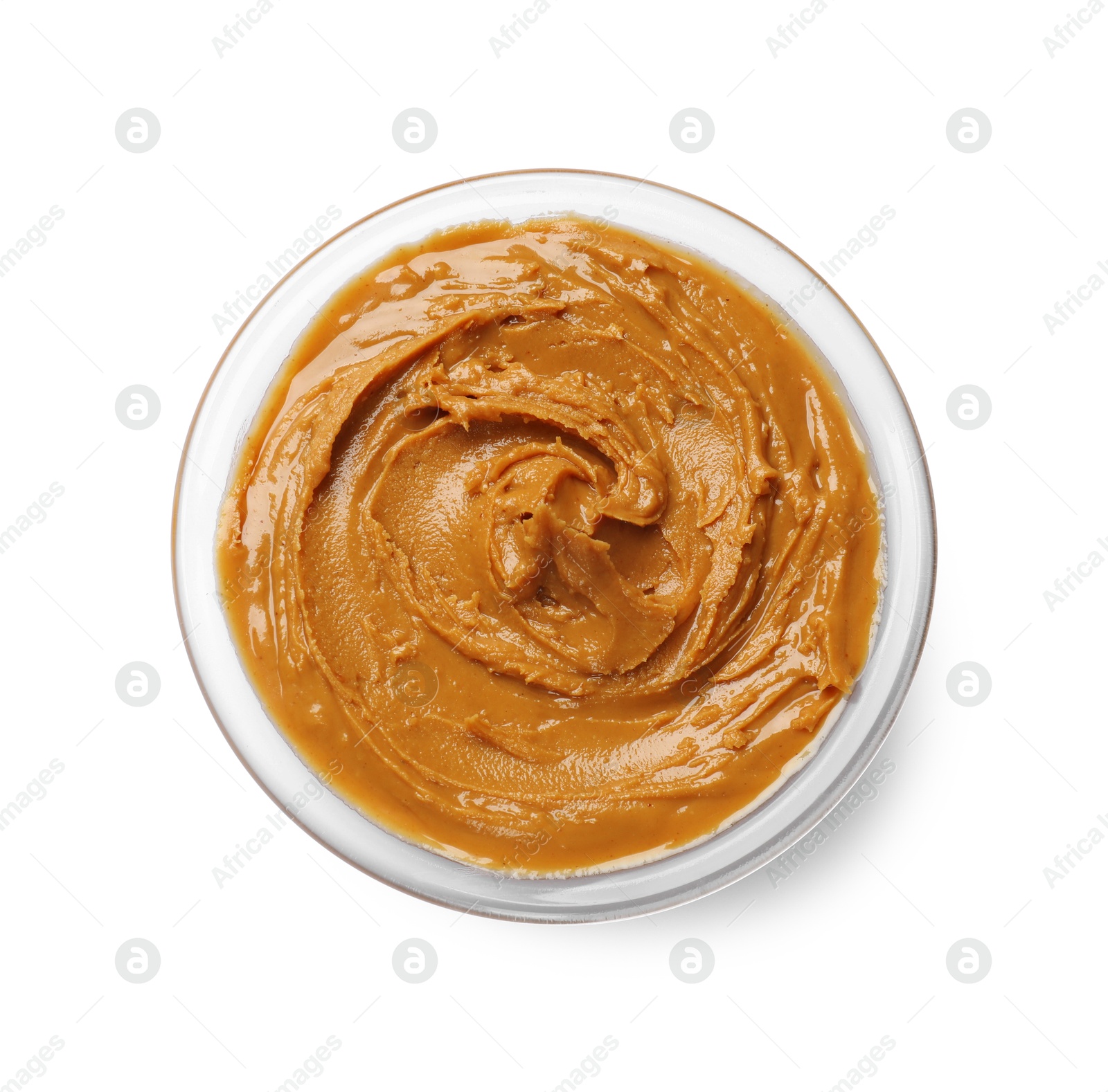 Photo of Tasty peanut butter in bowl isolated on white, top view