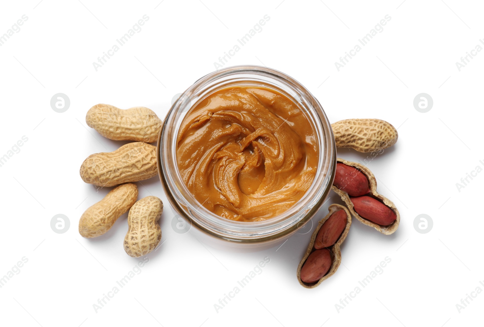 Photo of Tasty peanut butter in bowl and groundnuts isolated on white, top view