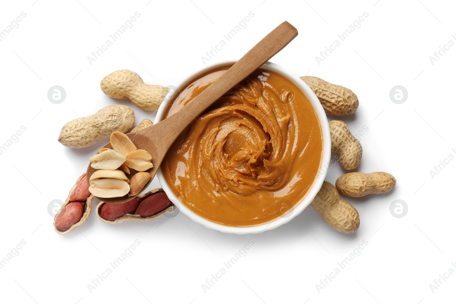 Photo of Tasty peanut butter in bowl, spoon and groundnuts isolated on white, top view