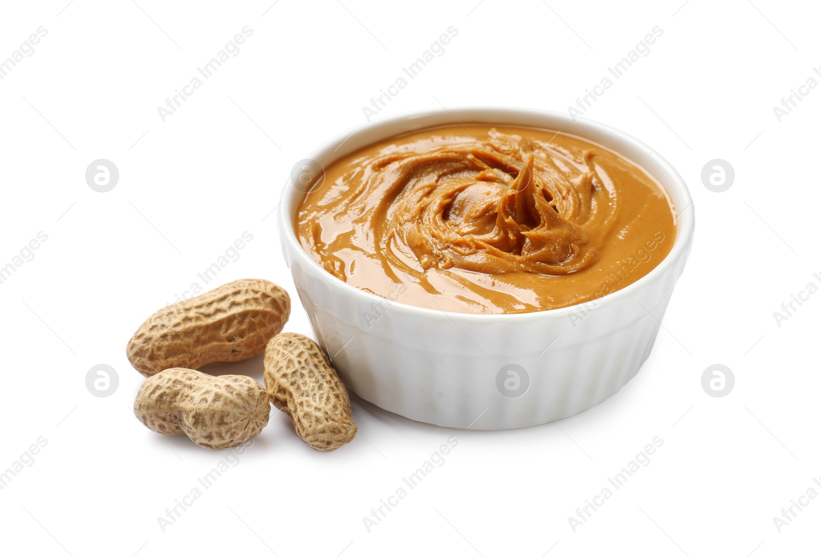 Photo of Tasty peanut butter in bowl and groundnuts isolated on white