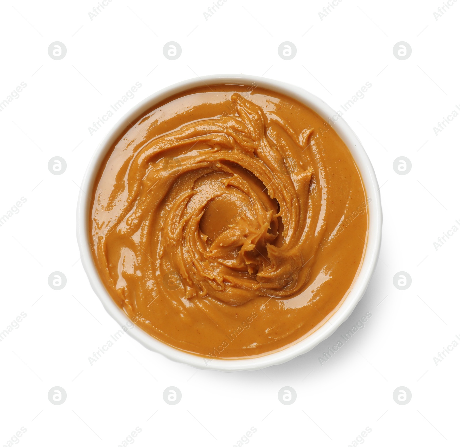 Photo of Tasty peanut butter in bowl isolated on white, top view