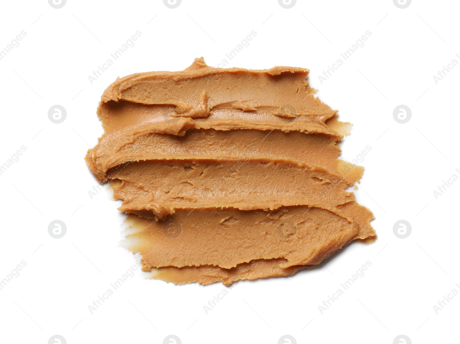 Photo of Smear of tasty peanut butter isolated on white, top view