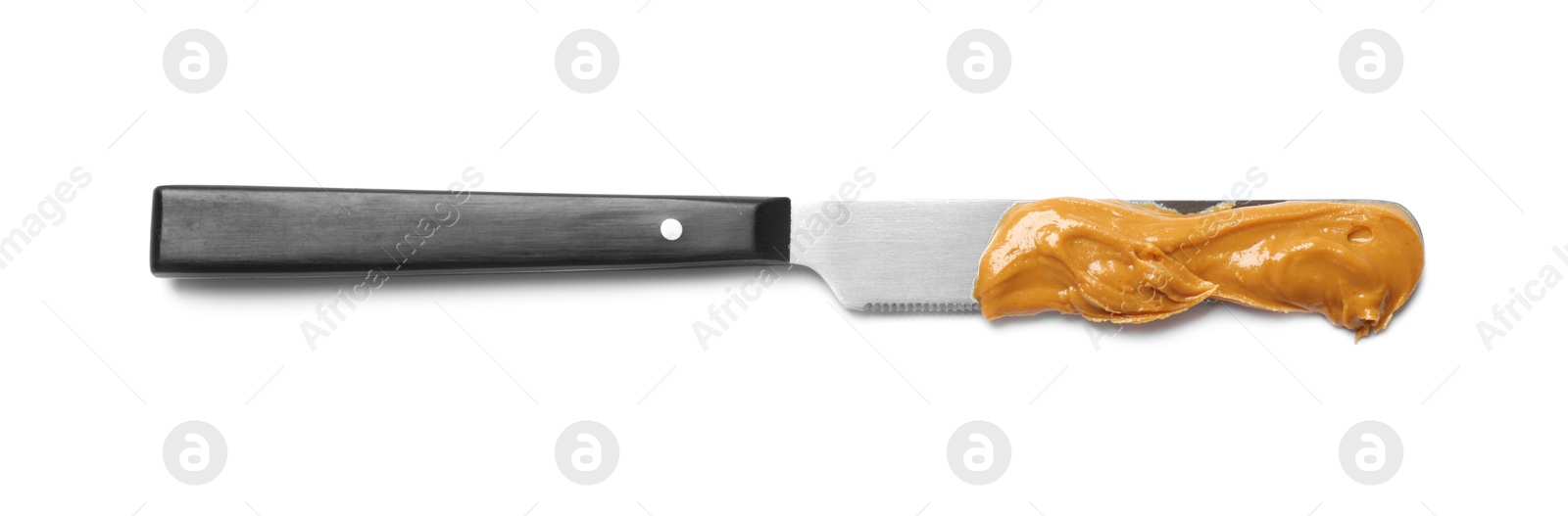 Photo of Knife with tasty peanut butter isolated on white, top view