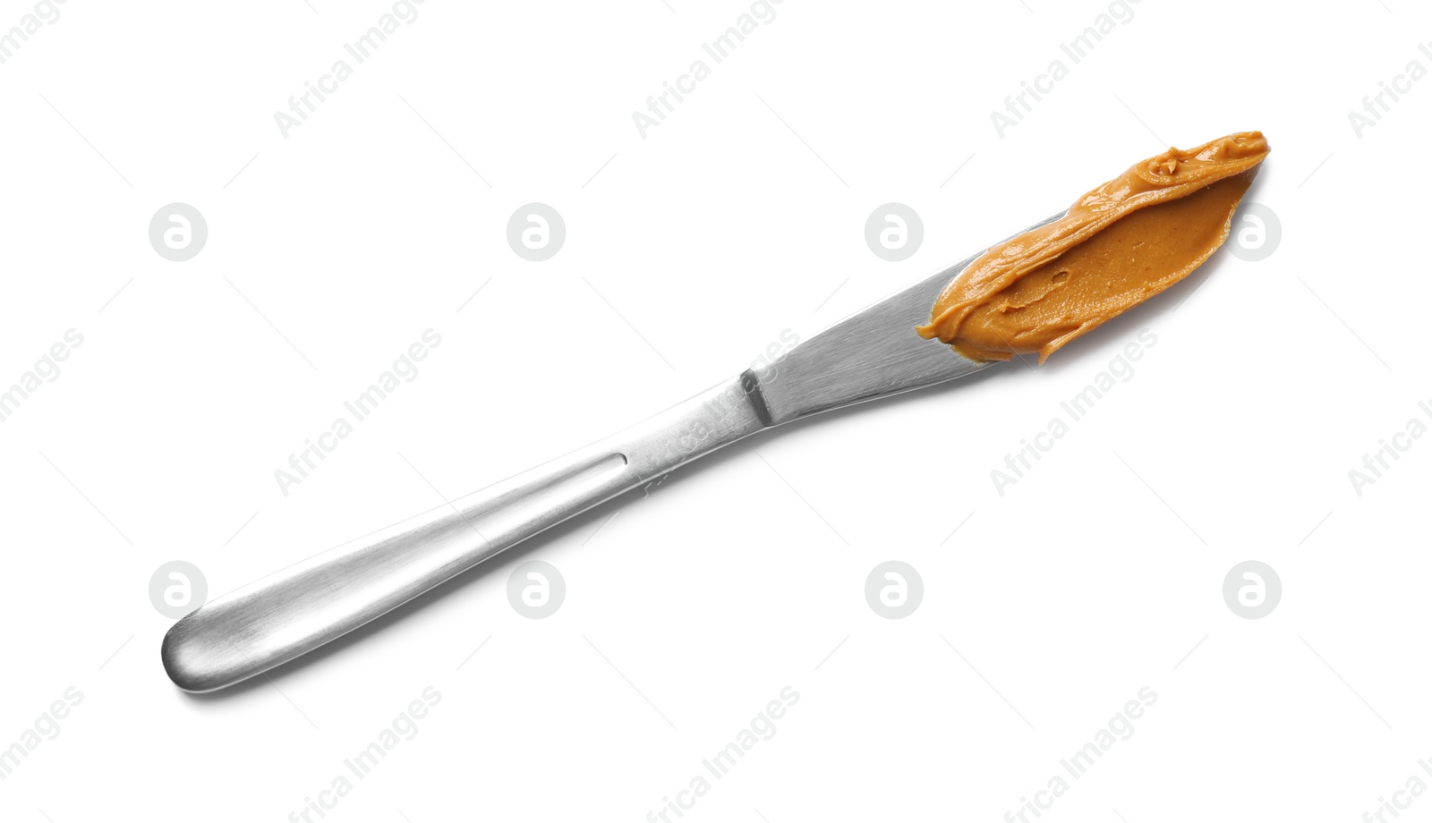 Photo of Knife with tasty peanut butter isolated on white, top view