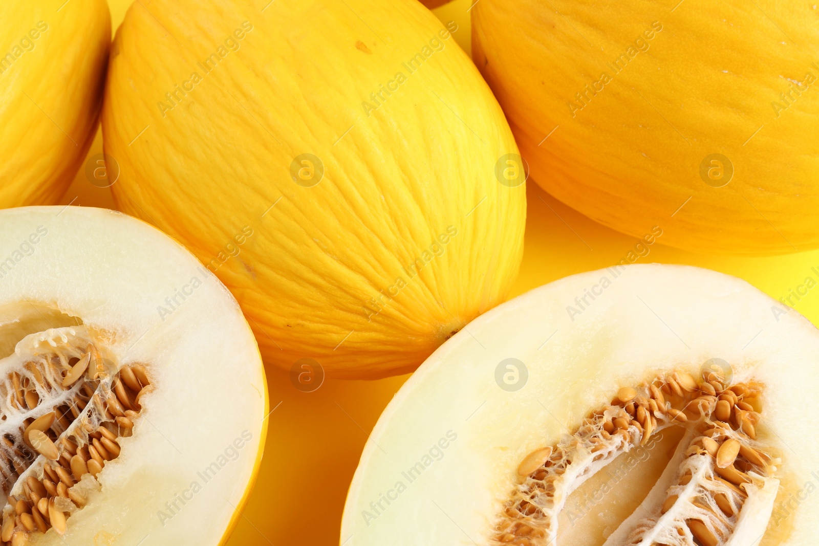 Photo of Whole and cut ripe melons as background, closeup