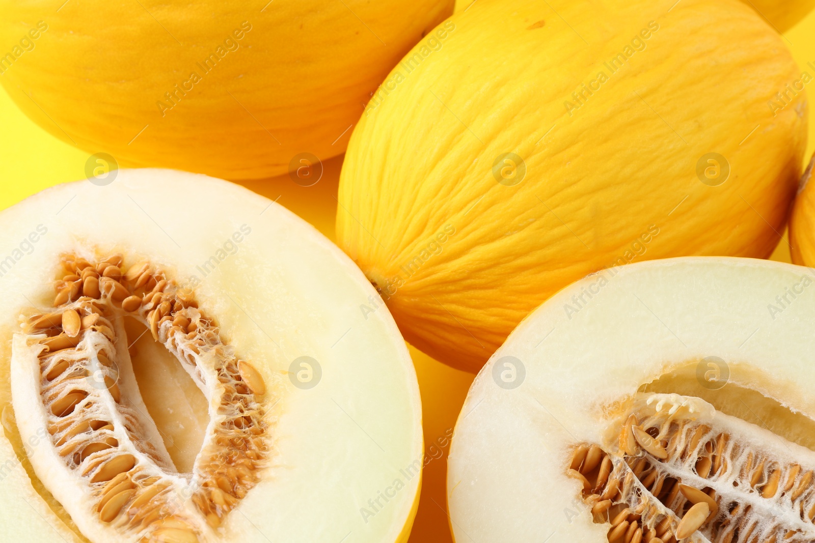 Photo of Whole and cut ripe melons as background, closeup