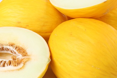 Photo of Whole and cut ripe melons as background, closeup