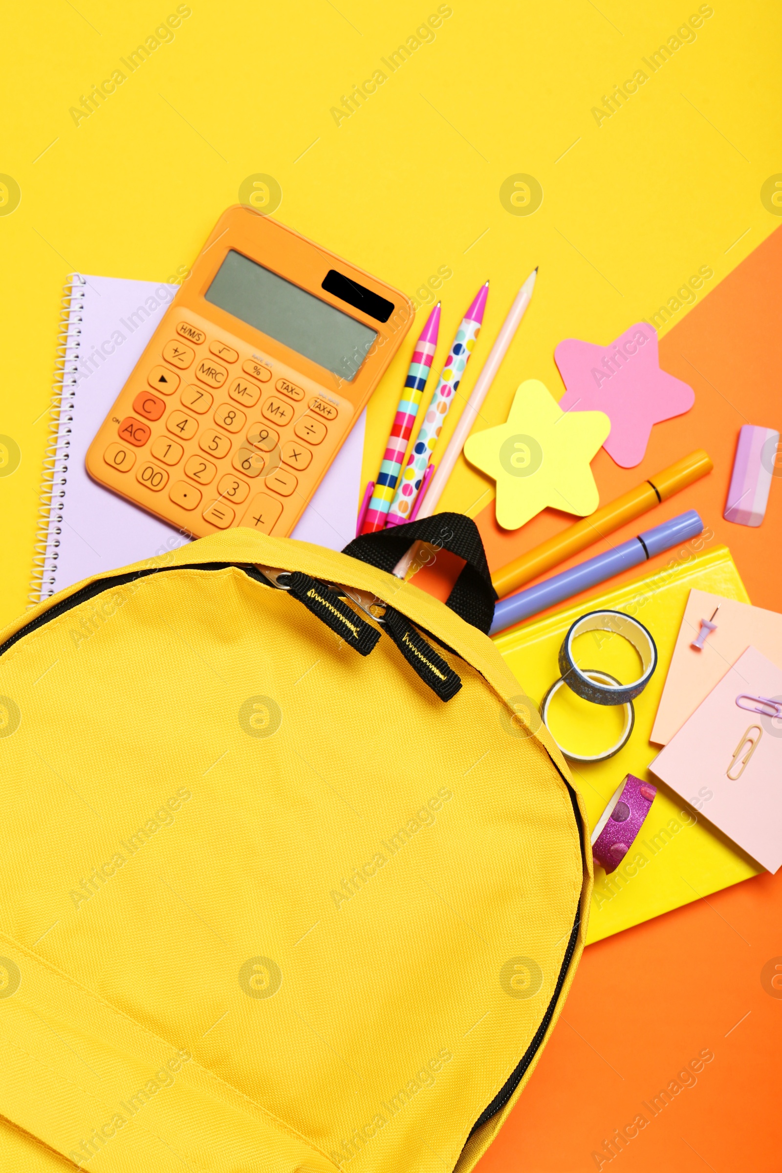 Photo of Backpack and different school stationery on color background, flat lay