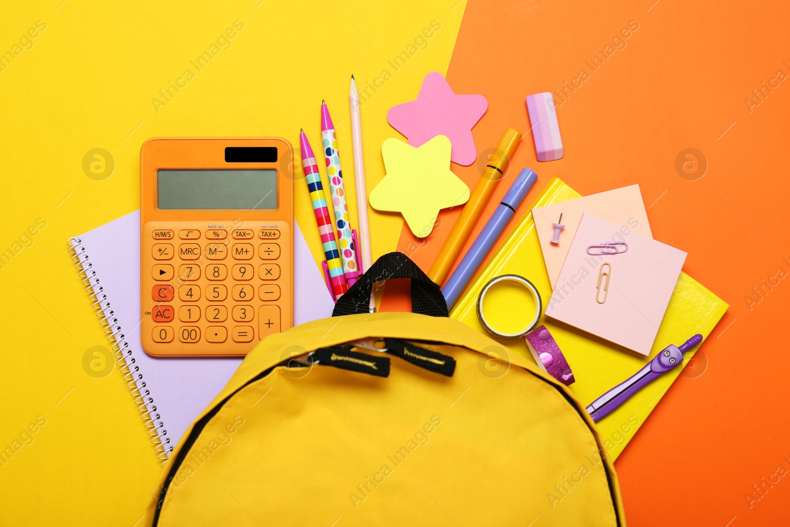 Photo of Backpack and different school stationery on color background, flat lay