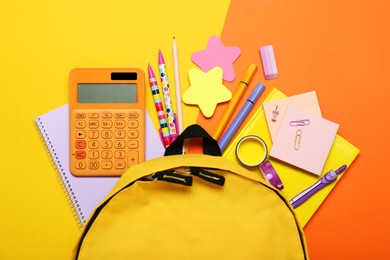 Photo of Backpack and different school stationery on color background, flat lay